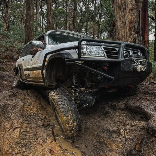 Jye Stephenson's Nissan Patrol flexing through a muddy forest trail with a Gigglepin winch motor brake system fitted by MBC, Victoria.