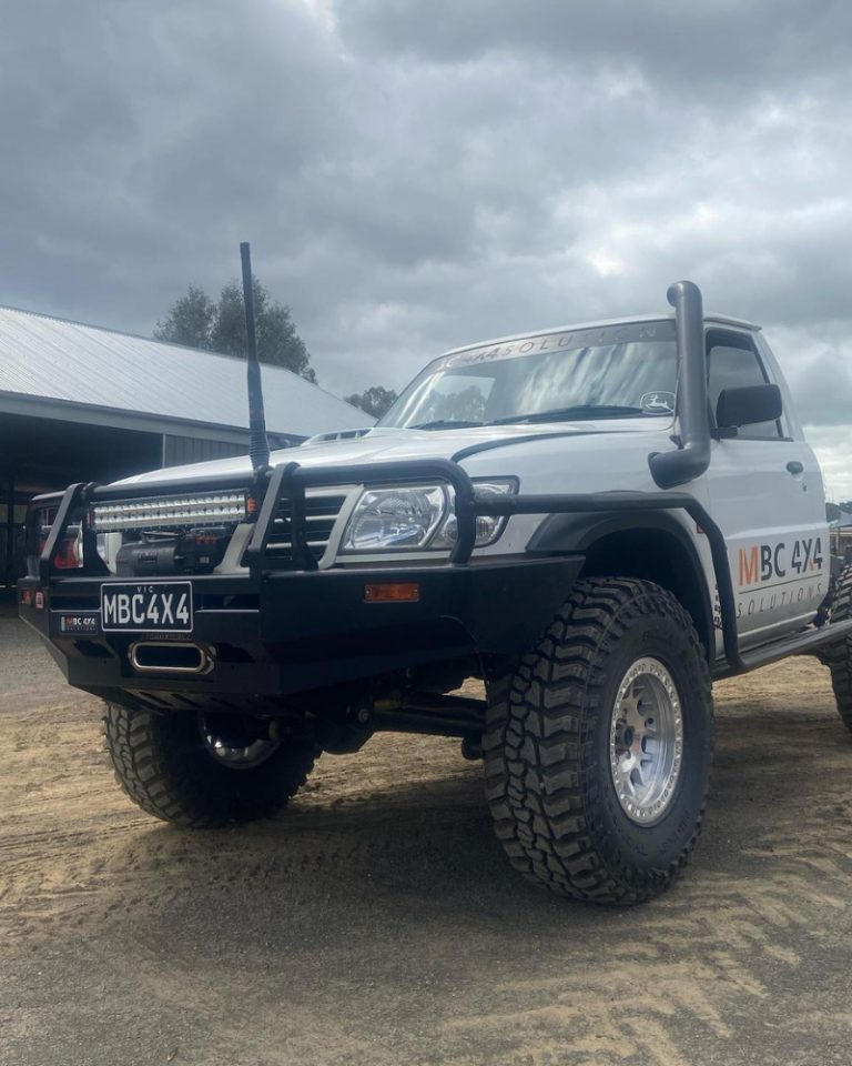 MBC 4X4 Solutions branded GU Nissan Patrol with custom bull bar, snorkel and mud tyres parked outside the workshop in Bendigo.