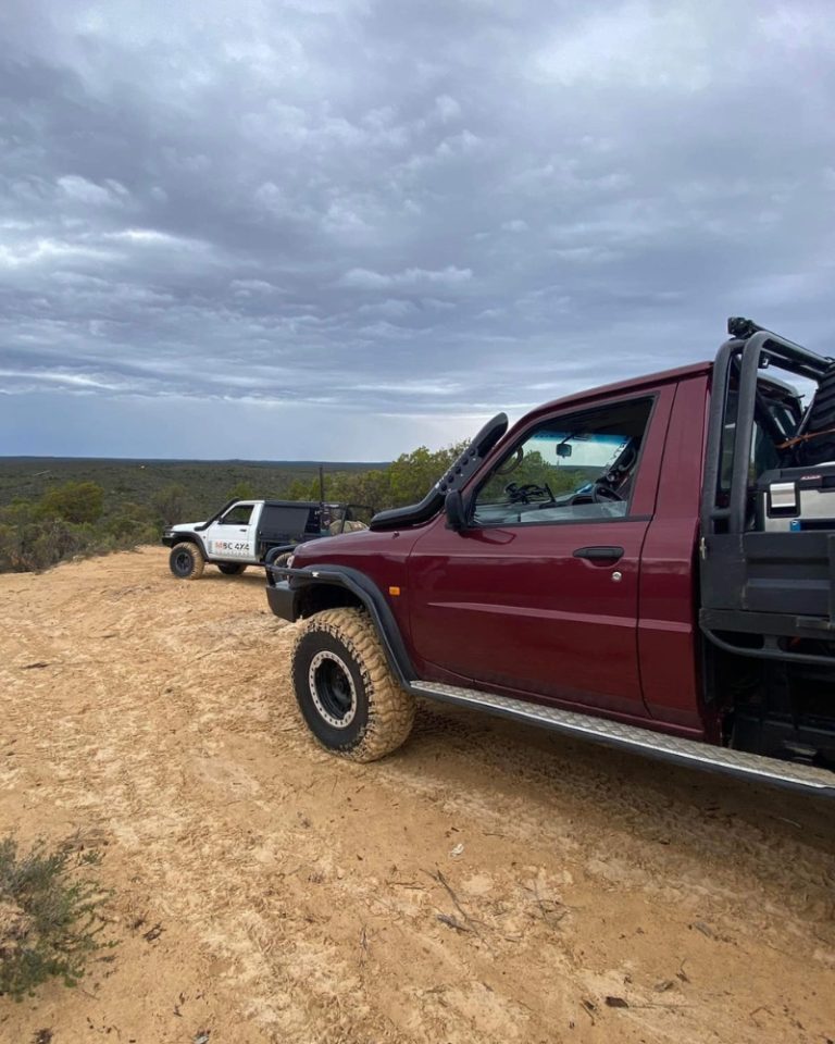 Maroon Patrol tray ute parked at a Central Victoria lookout next to an MBC 4X4 Solutions touring build.