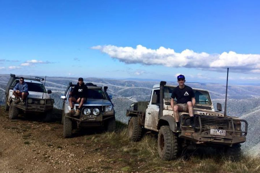 Mitch from MBC 4X4 Solutions and mates resting on the bonnets of their touring builds on a Victorian High Country ridge.