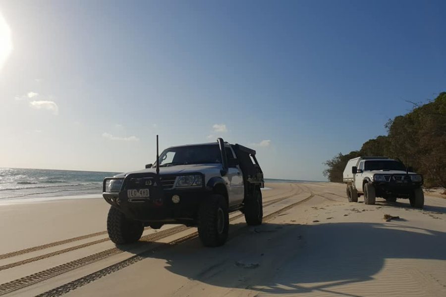 Patrol cab-chassis on a Victorian beach at sunset, set up for 4WD touring.