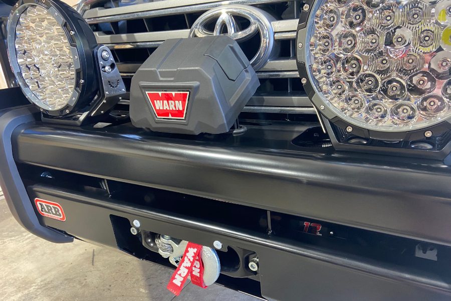 ARB Deluxe Big Tube bull bar with Warn VR EVO winch and customer supplied 9" round LED driving lights fitted to a 200 Series LandCruiser by MBC 4X4 Solutions, Bendigo