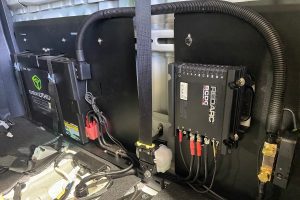 Custom lithium battery fitted behind the rear seat of a Toyota Hilux dual cab for a 4x4 touring build, with a Red Arc Alpha 50B charger, by MBC 4X4 Solutions in Bendigo