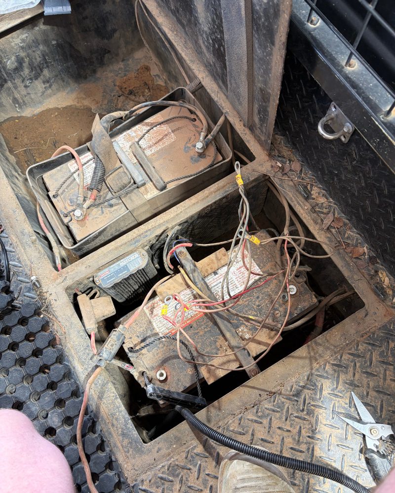 Messy, un-fused auxiliary battery wiring in an under-tray enclosure before MBC 4X4 Solutions rewired it, near Kangaroo Flat