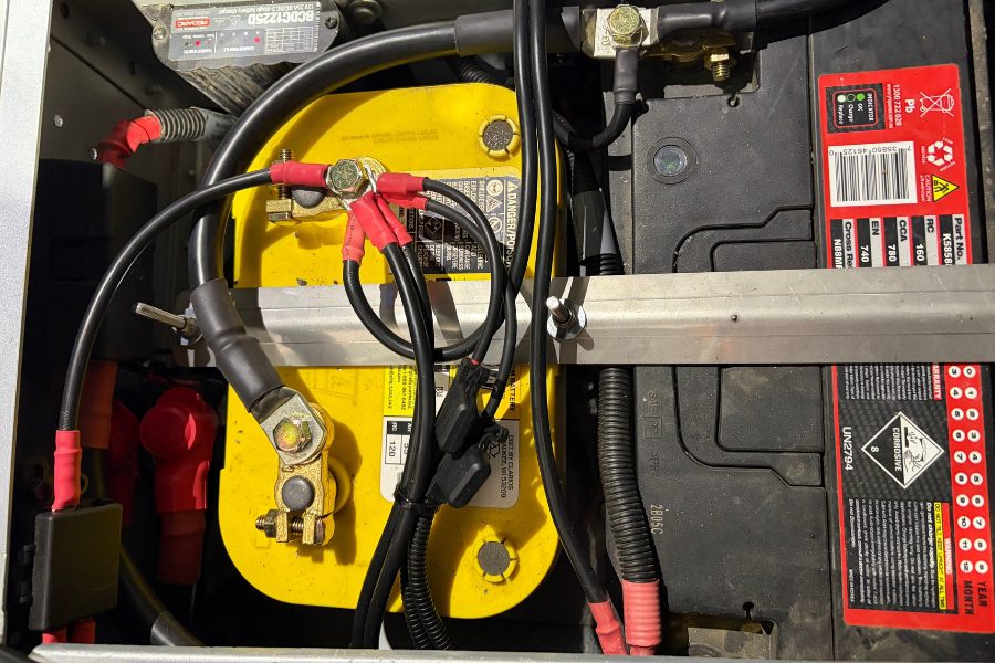 Optima Yellow Top AGM battery mounted under the seat in a Land Rover Defender with a Red Arc BCDC1225D charger, fitted by Mitch at MBC 4X4 Solutions near Castlemaine